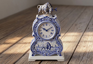 Blue and white ceramic IV bag ornament placed on a wooden surface.